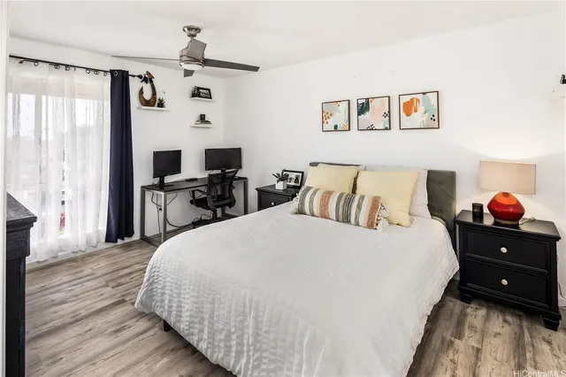 a bedroom with a bed and wooden floor