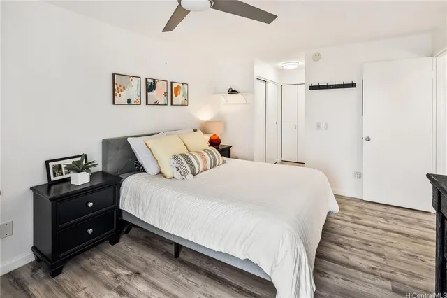 a bedroom with a bed and wooden floor