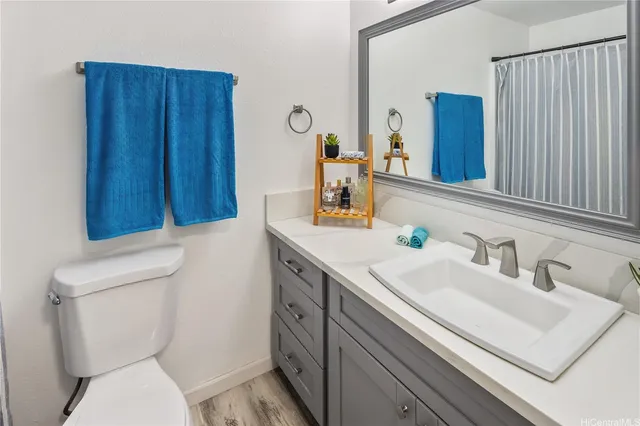 a bathroom with a sink a toilet and mirror