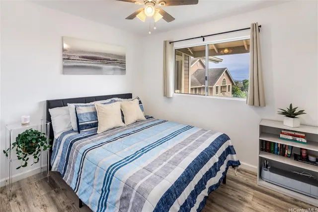 a bedroom with bed and wooden floor