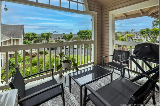 a view of a balcony with chairs and wooden floor