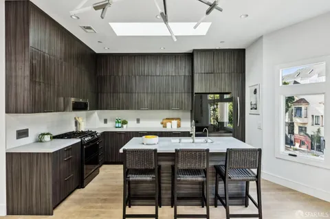 a kitchen with a table chairs stove and cabinets