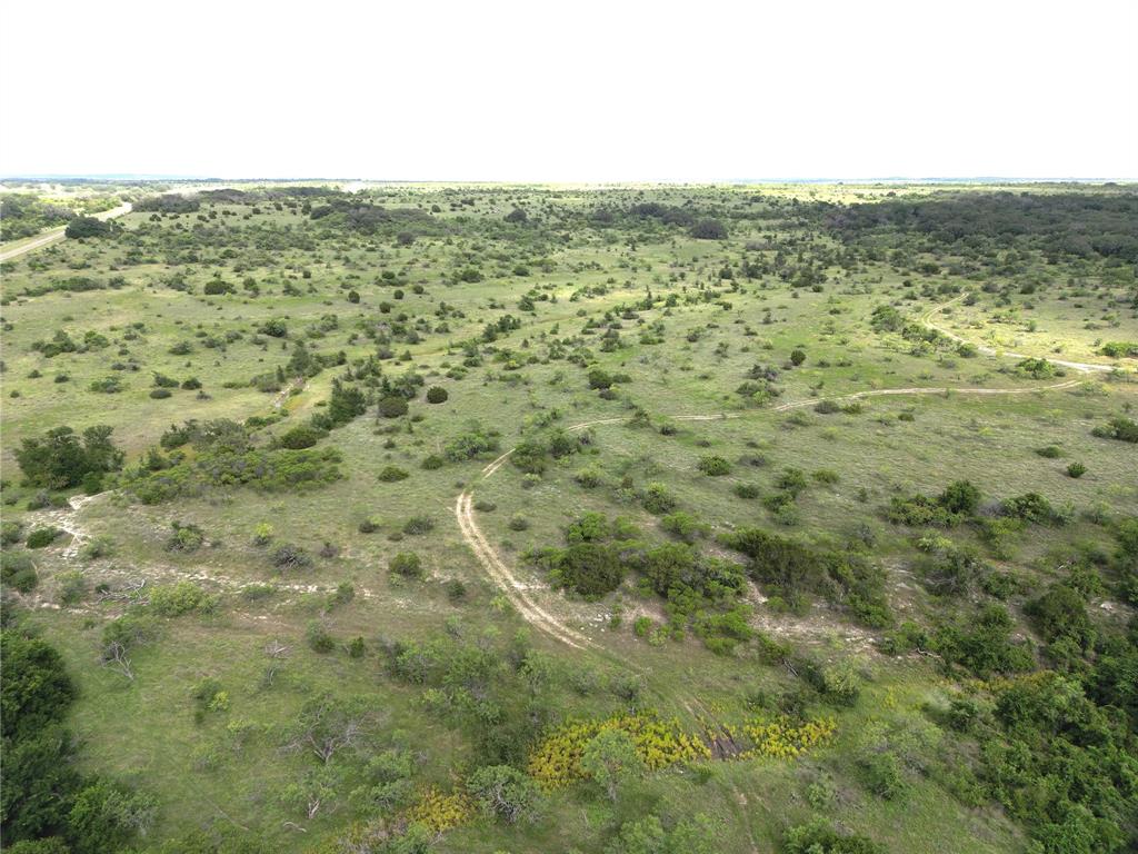 2486 & Cr Hamilton, TX 76531 - Photo 26 of 31 a view of a green field with two buildings in the background