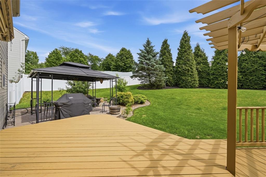 4003 Oak Point Circle McKees Rocks, PA 15136 - Photo 37 of 50 The backyard combines a spacious lawn, mature trees, and a beautifully integrated patio area ideal for entertaining and everyday enjoyment. Well-maintained landscaping reinforces the home’s immaculate overall presentation.