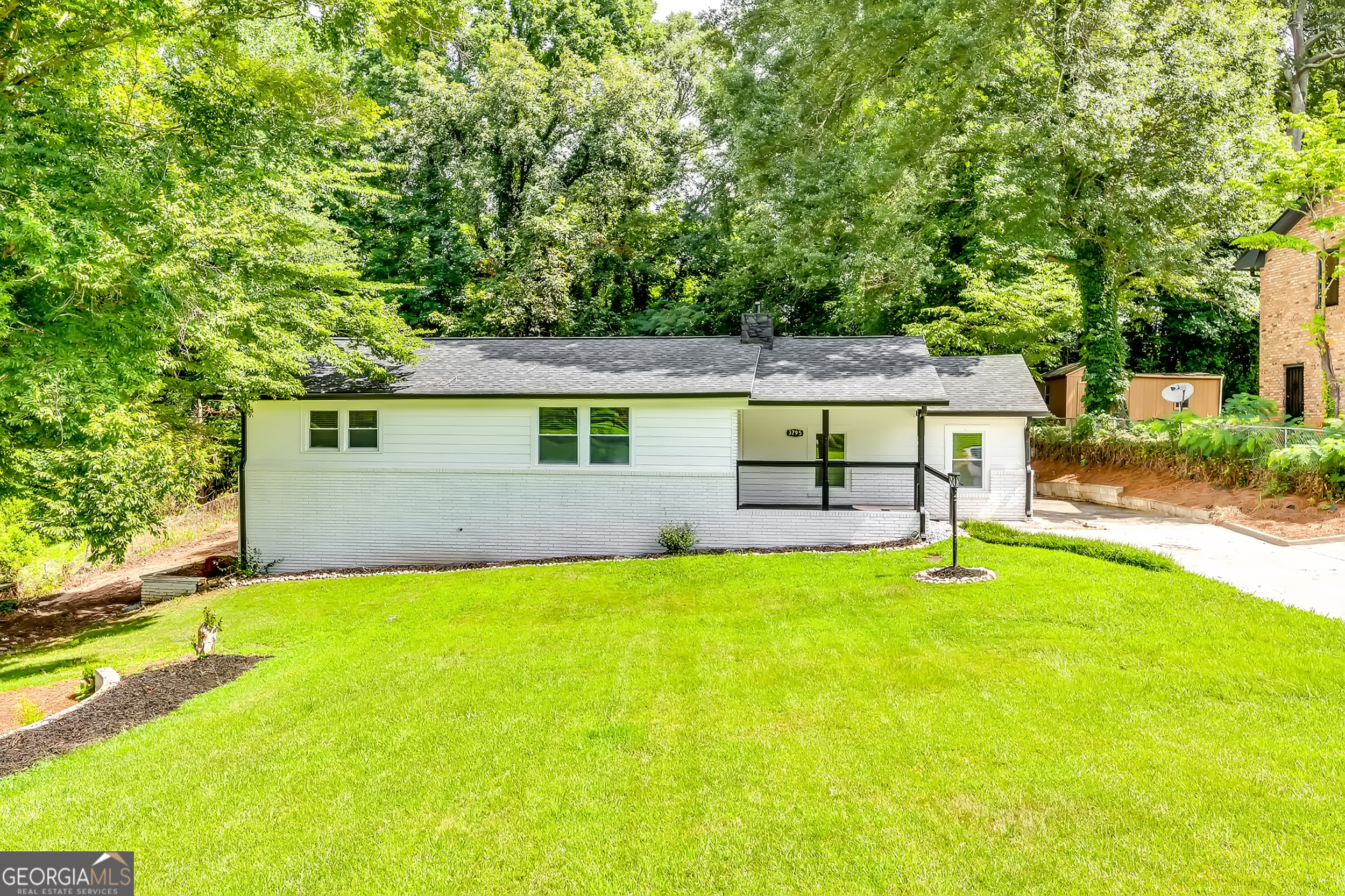 a view of a house with a yard and a patio