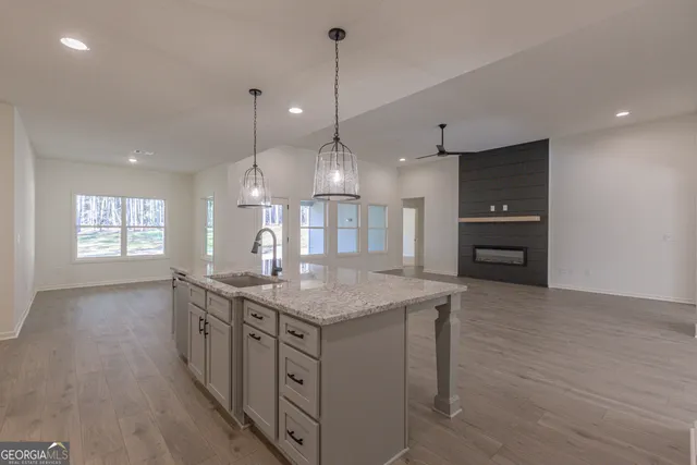 an empty room with closet and a chandelier fan