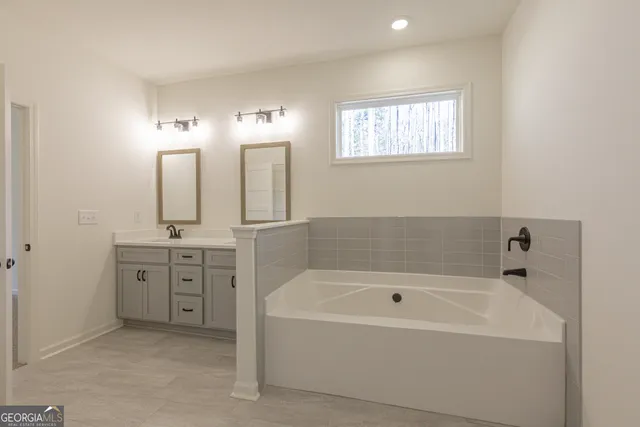 a bathroom with a granite countertop sink mirror and a