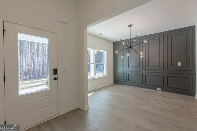a kitchen with stainless steel appliances granite countertop a kitchen island a stove and a wooden floors