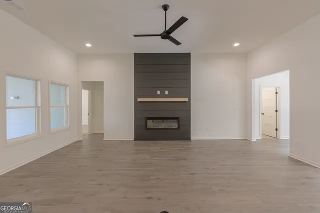 a kitchen with granite countertop white cabinets and stainless steel appliances