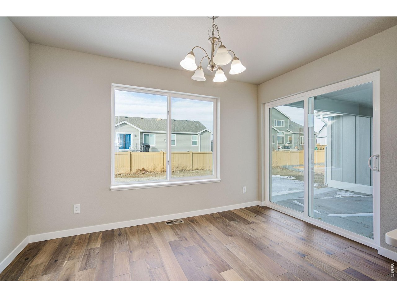 7040 Feather Reed Drive Wellington, CO 80549 - Photo 14 of 32 a view of an empty room with wooden floor and a window