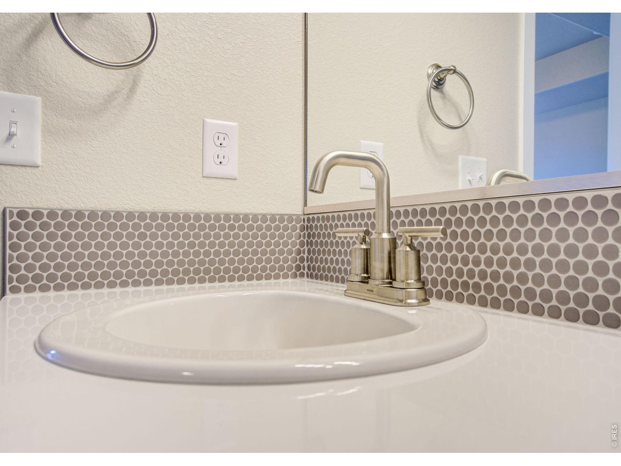 7040 Feather Reed Drive Wellington, CO 80549 - Photo 20 of 32 a bathroom with a sink and a mirror