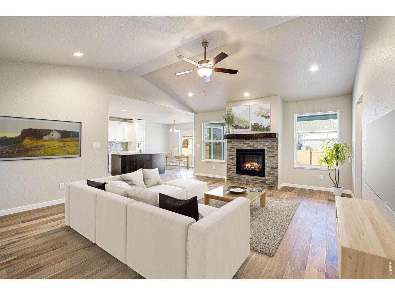 7040 Feather Reed Drive Wellington, CO 80549 - Photo 2 of 32 a living room with furniture a fireplace and wooden floor