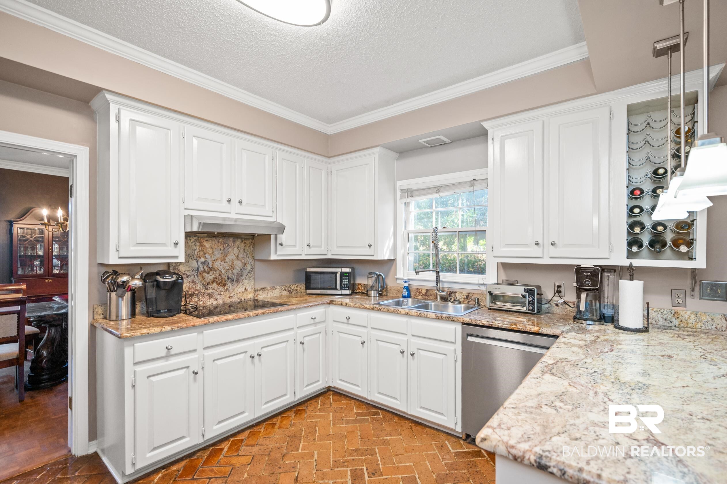 6705 Ridgeland Road South Mobile, AL 36695 - Photo 12 of 44 Kitchen with appliances with stainless steel finishes, sink, a textured ceiling, white cabinets, and crown molding