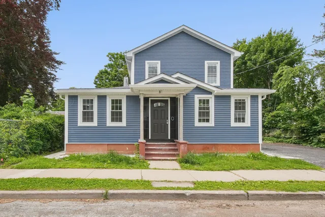a front view of a house with a yard