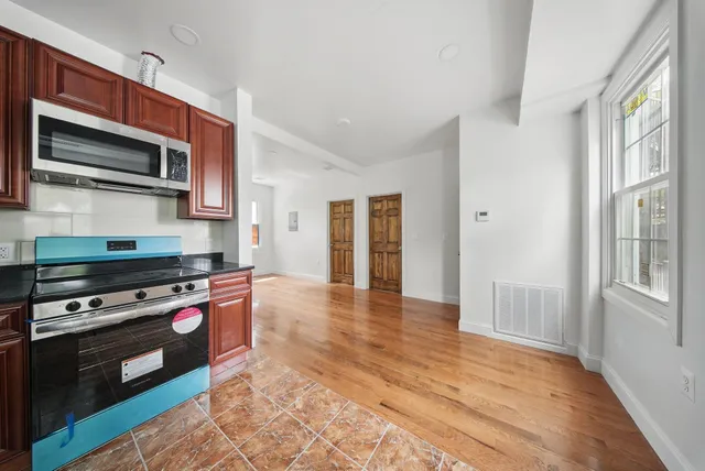 a kitchen with stainless steel appliances a stove a microwave and cabinets
