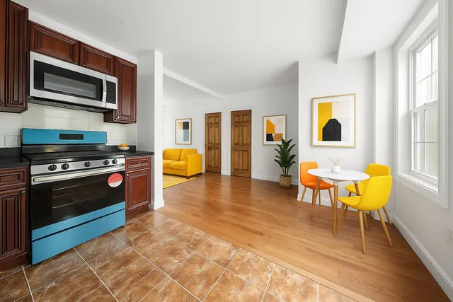 a kitchen with stainless steel appliances granite countertop a stove a sink and a microwave