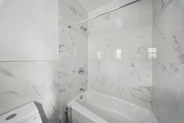 a bathroom with a bathtub and a shower