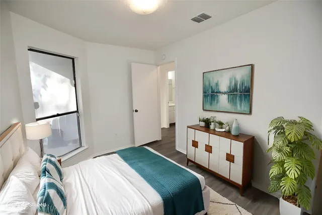 a bedroom with a bed and a window