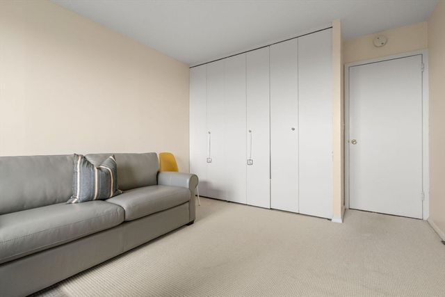 a living room with a couch and a white door