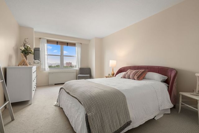 a bedroom with a large bed and a window