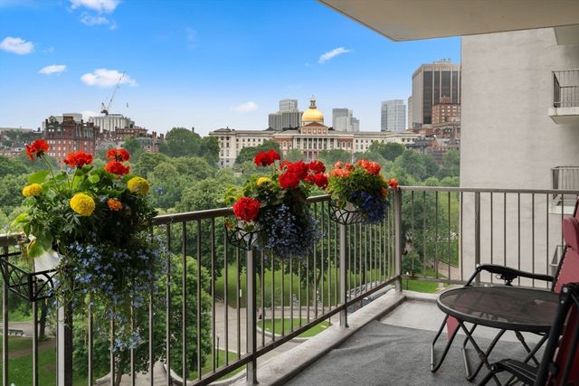 a view of a balcony with flower plants