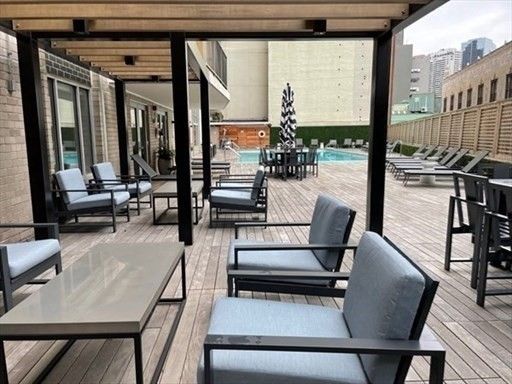 a view of a patio with table and chairs and potted plants