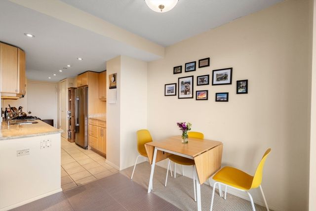 a living room with a couch and a view of kitchen