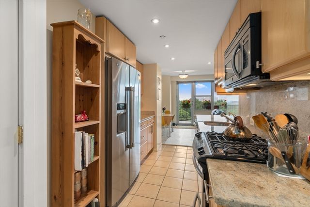 a kitchen with stainless steel appliances granite countertop a refrigerator and a stove