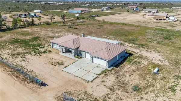 an aerial view of a house with a yard and lake view