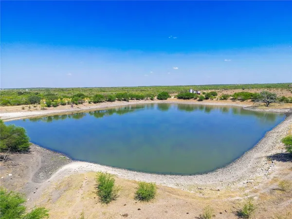a view of a lake with a yard