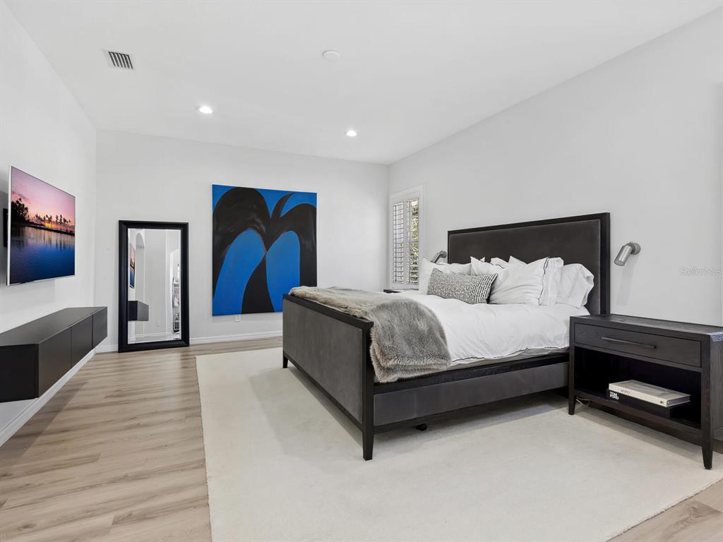 2159 Hawthorne Street Sarasota, FL 34239 - Photo 20 of 47 a spacious bedroom with a bed and a flat screen tv