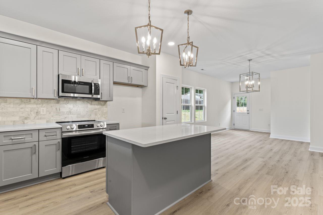 751 Mockingbird Road, Unit 1 Albemarle, NC 28001 - Photo 12 of 29 a kitchen with stainless steel appliances granite countertop a stove and a sink