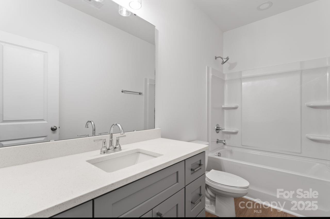 751 Mockingbird Road, Unit 1 Albemarle, NC 28001 - Photo 14 of 29 a bathroom with a sink toilet a mirror and bathtub