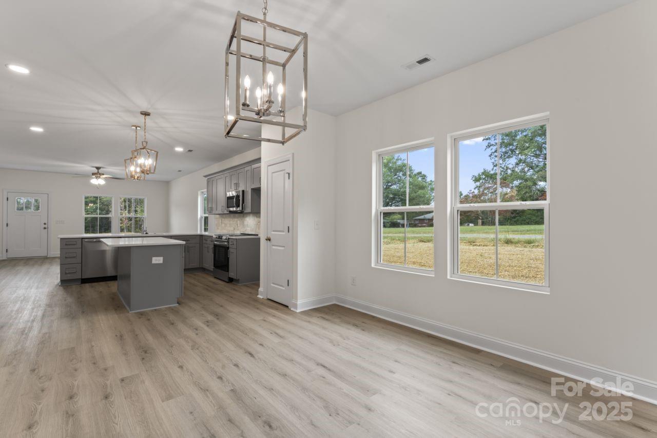 751 Mockingbird Road, Unit 1 Albemarle, NC 28001 - Photo 21 of 29 a view of a kitchen with a sink wooden floor and a large window