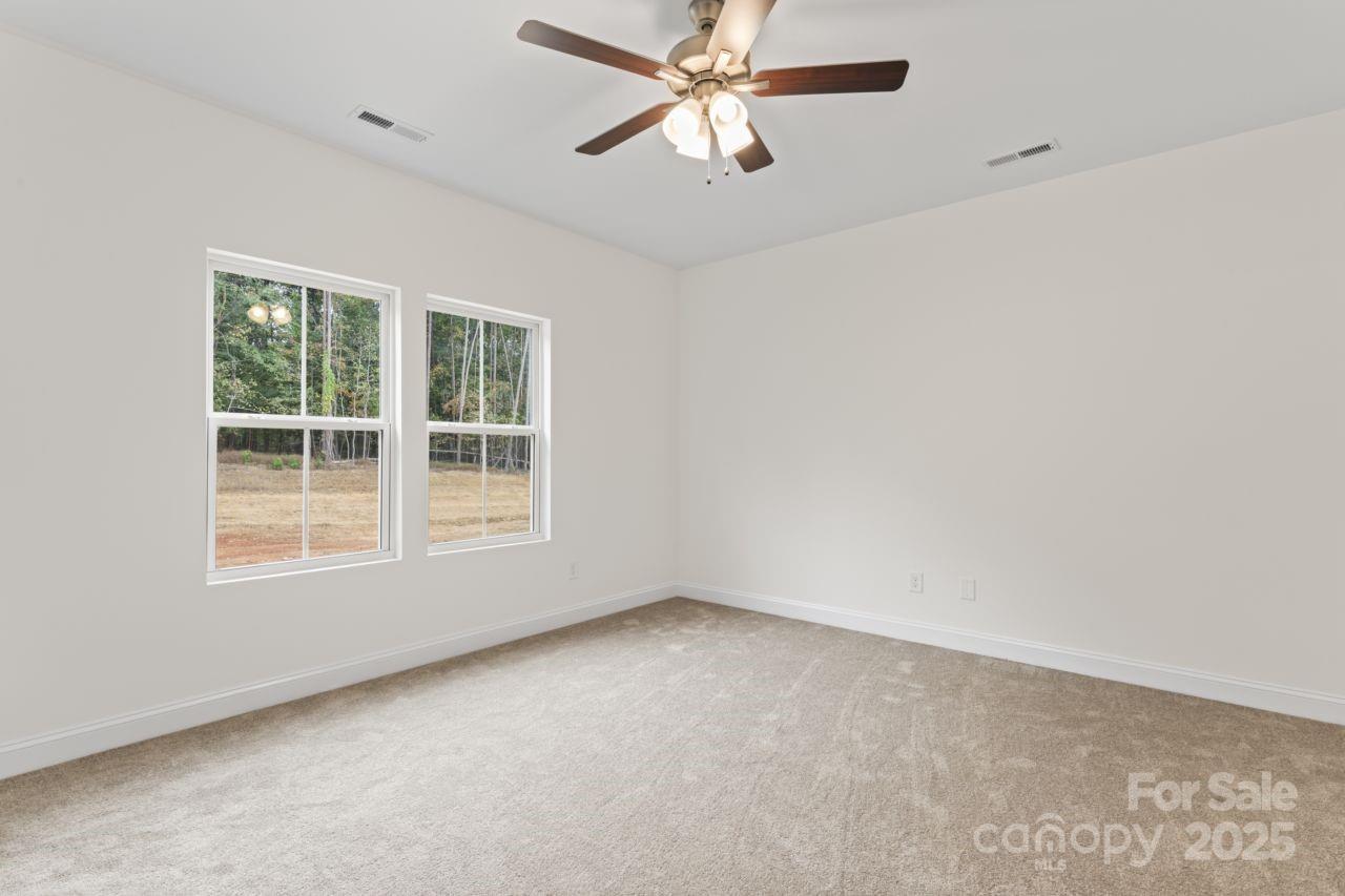 751 Mockingbird Road, Unit 1 Albemarle, NC 28001 - Photo 22 of 29 an empty room with a window and a fan