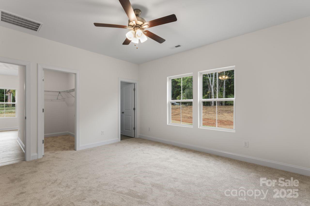 751 Mockingbird Road, Unit 1 Albemarle, NC 28001 - Photo 23 of 29 an empty room with windows and fan