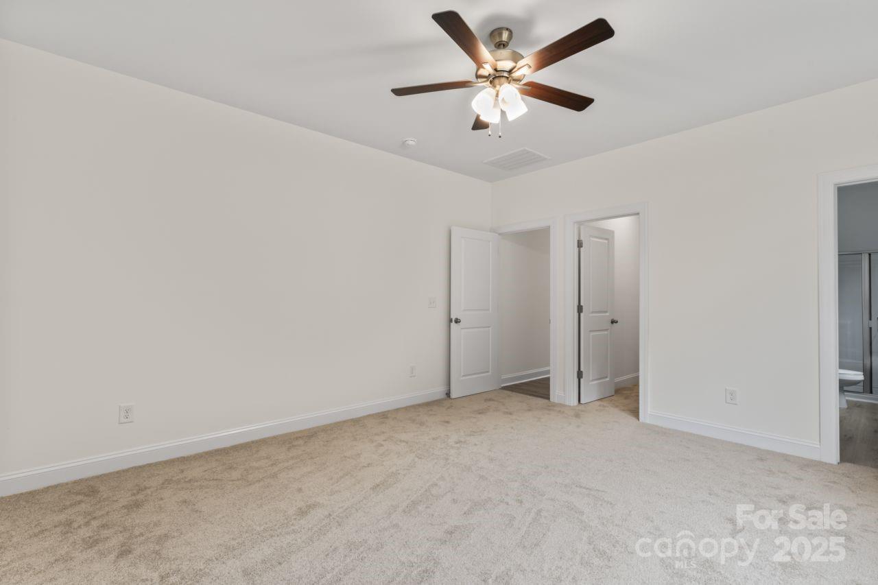 751 Mockingbird Road, Unit 1 Albemarle, NC 28001 - Photo 24 of 29 an empty room with a ceiling fan and a window
