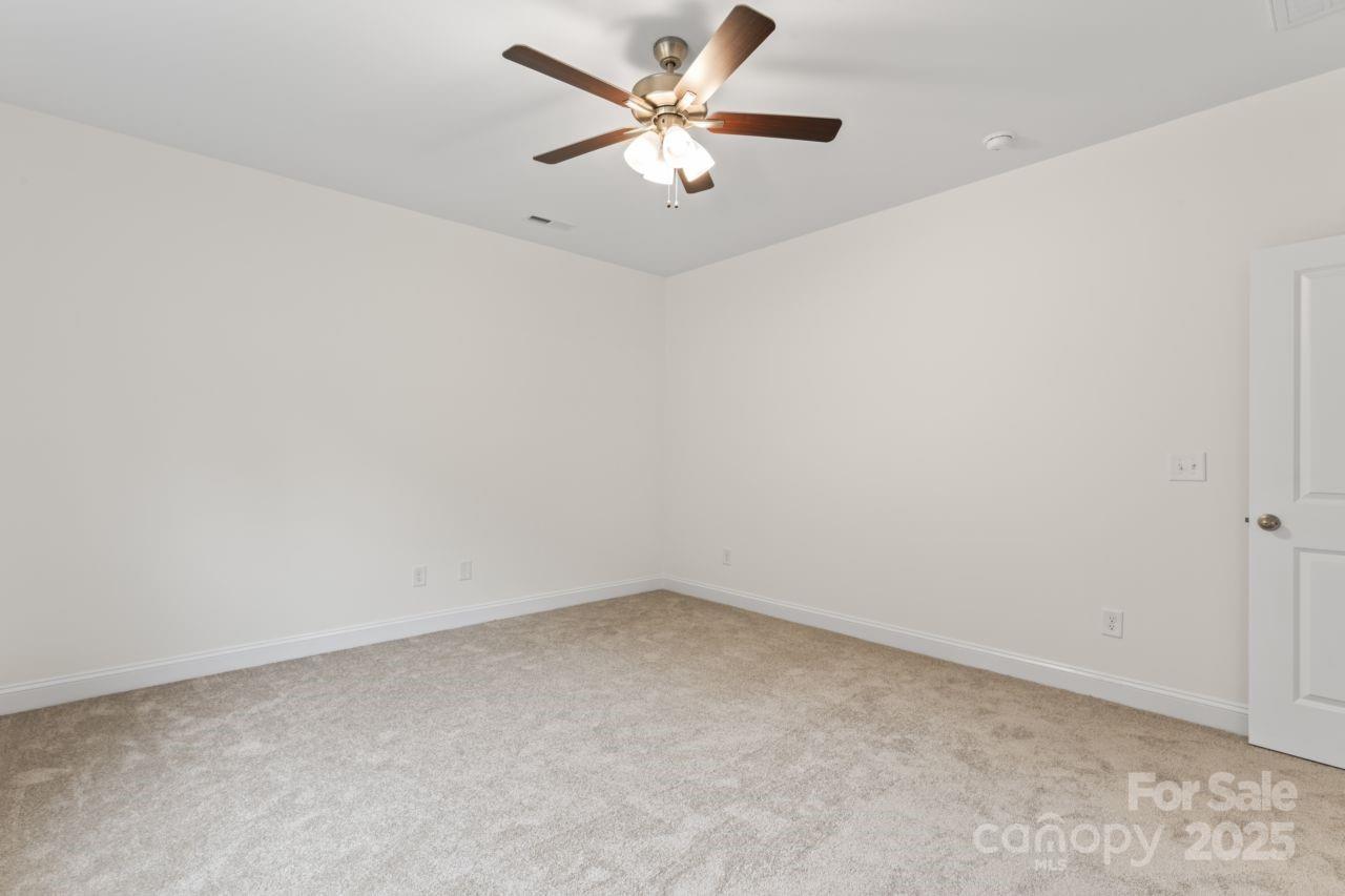 751 Mockingbird Road, Unit 1 Albemarle, NC 28001 - Photo 25 of 29 an empty room with a window and a ceiling fan