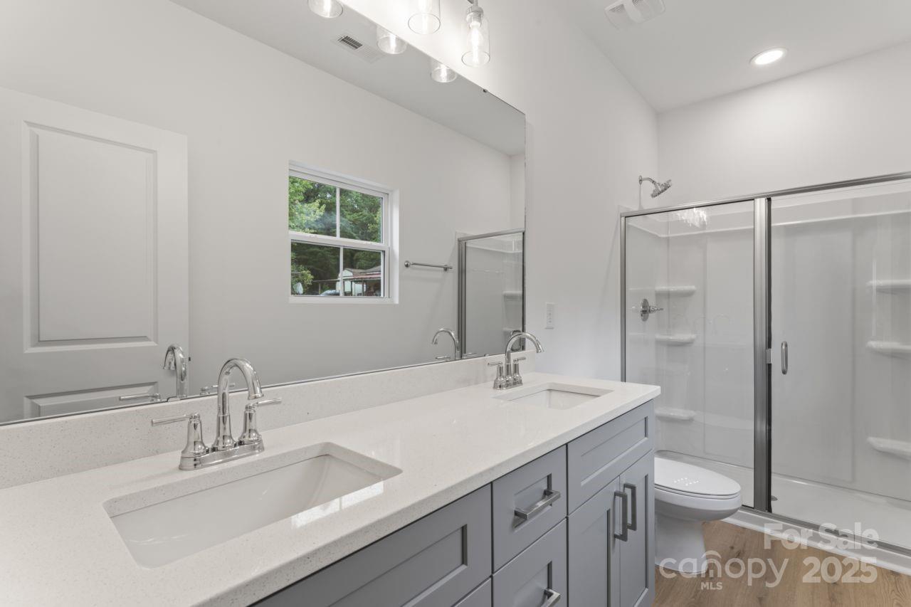 751 Mockingbird Road, Unit 1 Albemarle, NC 28001 - Photo 26 of 29 a bathroom with a sink a toilet and shower