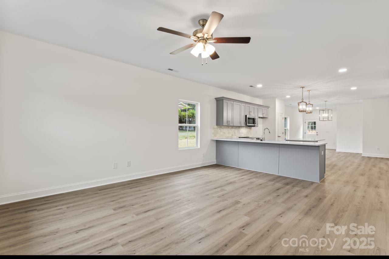 751 Mockingbird Road, Unit 1 Albemarle, NC 28001 - Photo 7 of 29 a view of kitchen with wooden floor and window