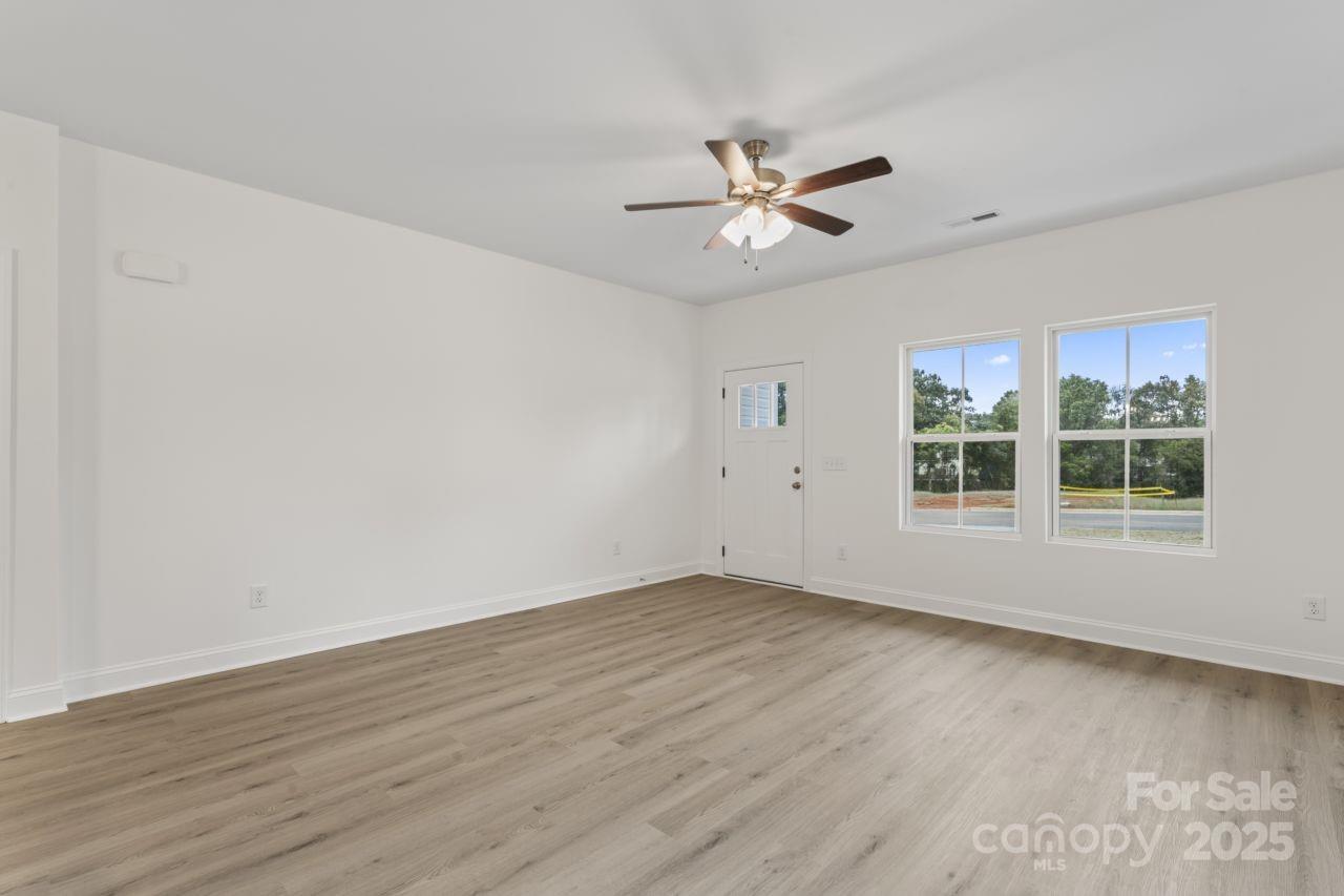 751 Mockingbird Road, Unit 1 Albemarle, NC 28001 - Photo 9 of 29 a view of empty room with wooden floor and fan