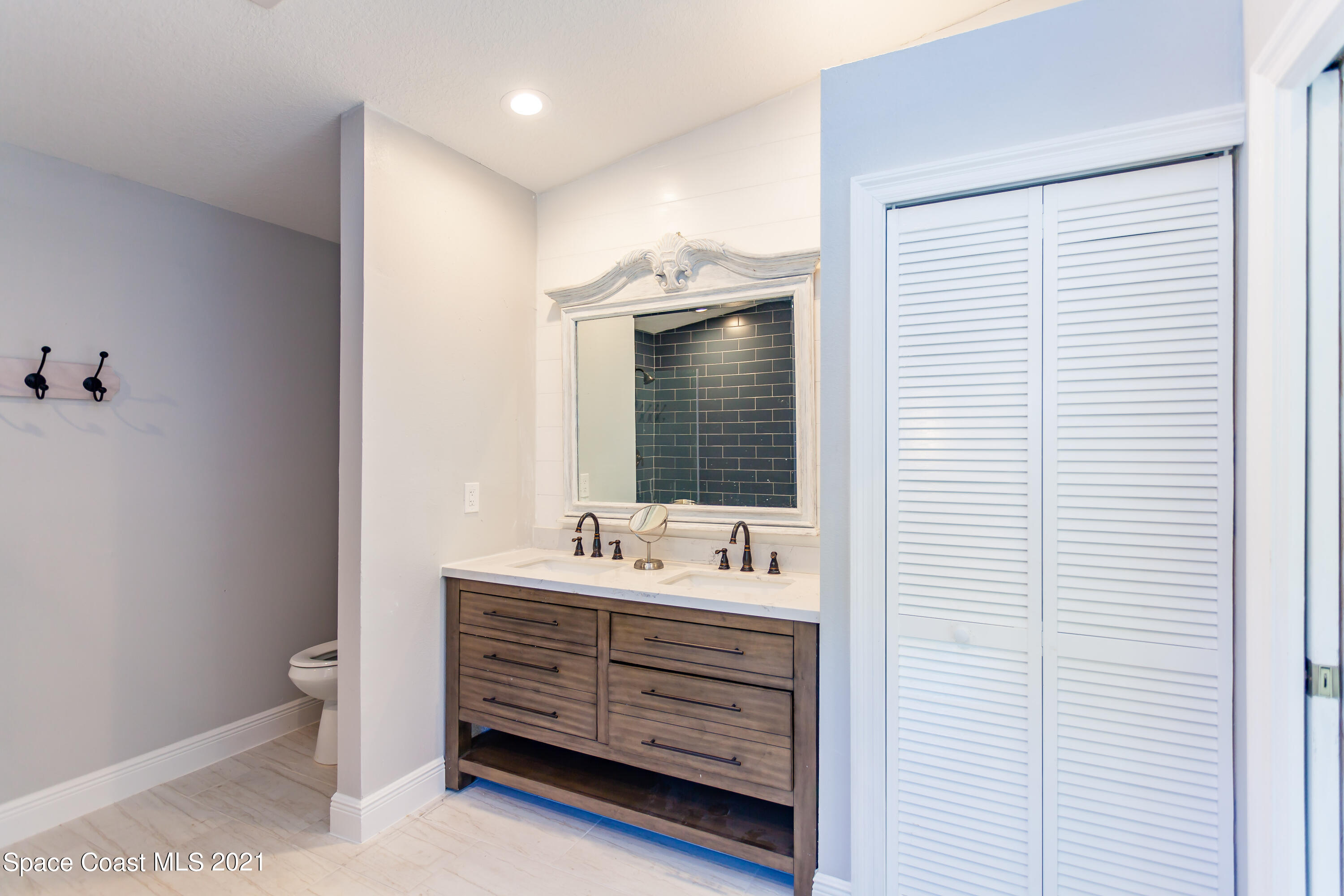 3400 Harlock Road Melbourne, FL 32934 - Photo 22 of 28 a bathroom with a sink and a mirror