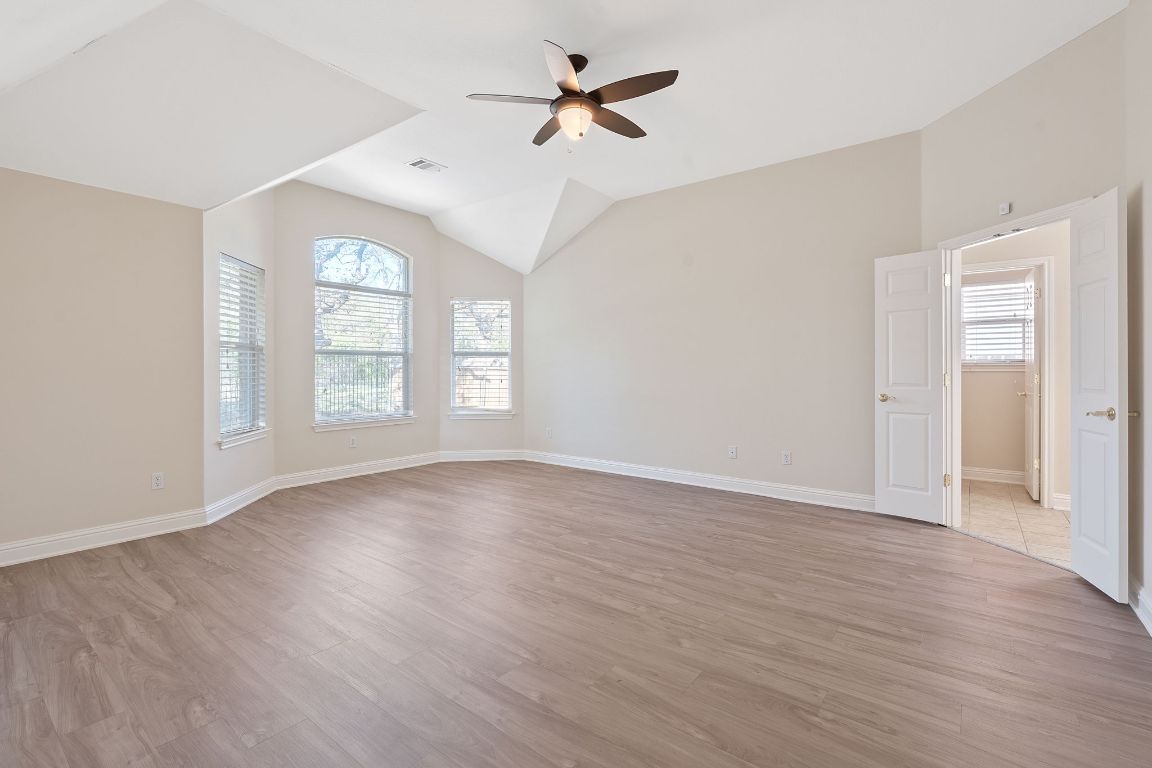 738 Nelson Ranch Road Cedar Park, TX 78613 - Photo 18 of 35 Spare room with light wood-style flooring, vaulted ceiling, and ceiling fan