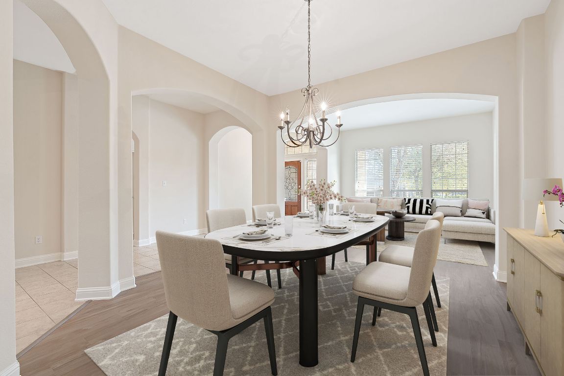 738 Nelson Ranch Road Cedar Park, TX 78613 - Photo 2 of 35 Dining space with arched walkways, baseboards, wood finished floors, and an inviting chandelier