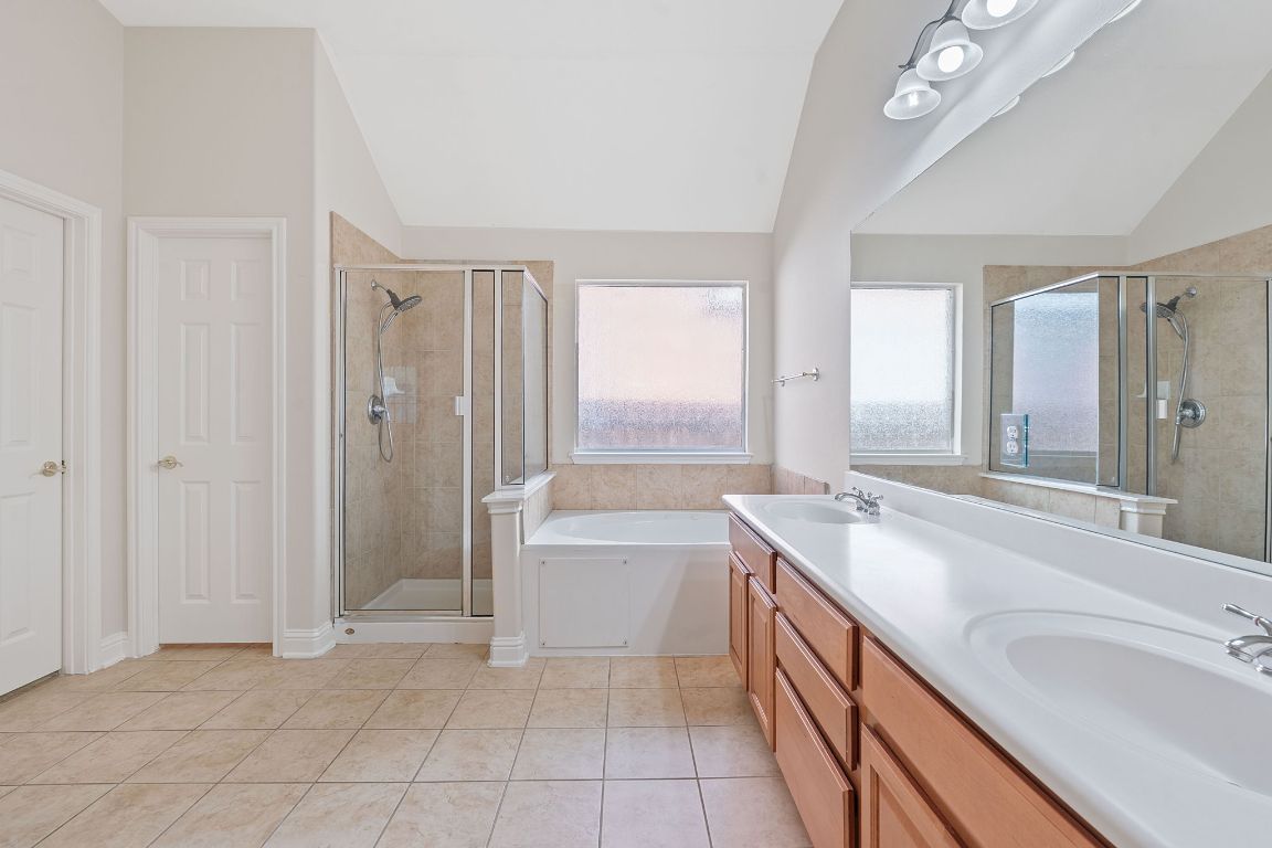738 Nelson Ranch Road Cedar Park, TX 78613 - Photo 23 of 35 Full bathroom with a sink, vaulted ceiling, and a shower stall