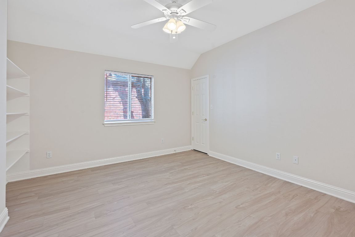 738 Nelson Ranch Road Cedar Park, TX 78613 - Photo 26 of 35 Unfurnished room featuring baseboards, ceiling fan, vaulted ceiling, and light wood finished floors