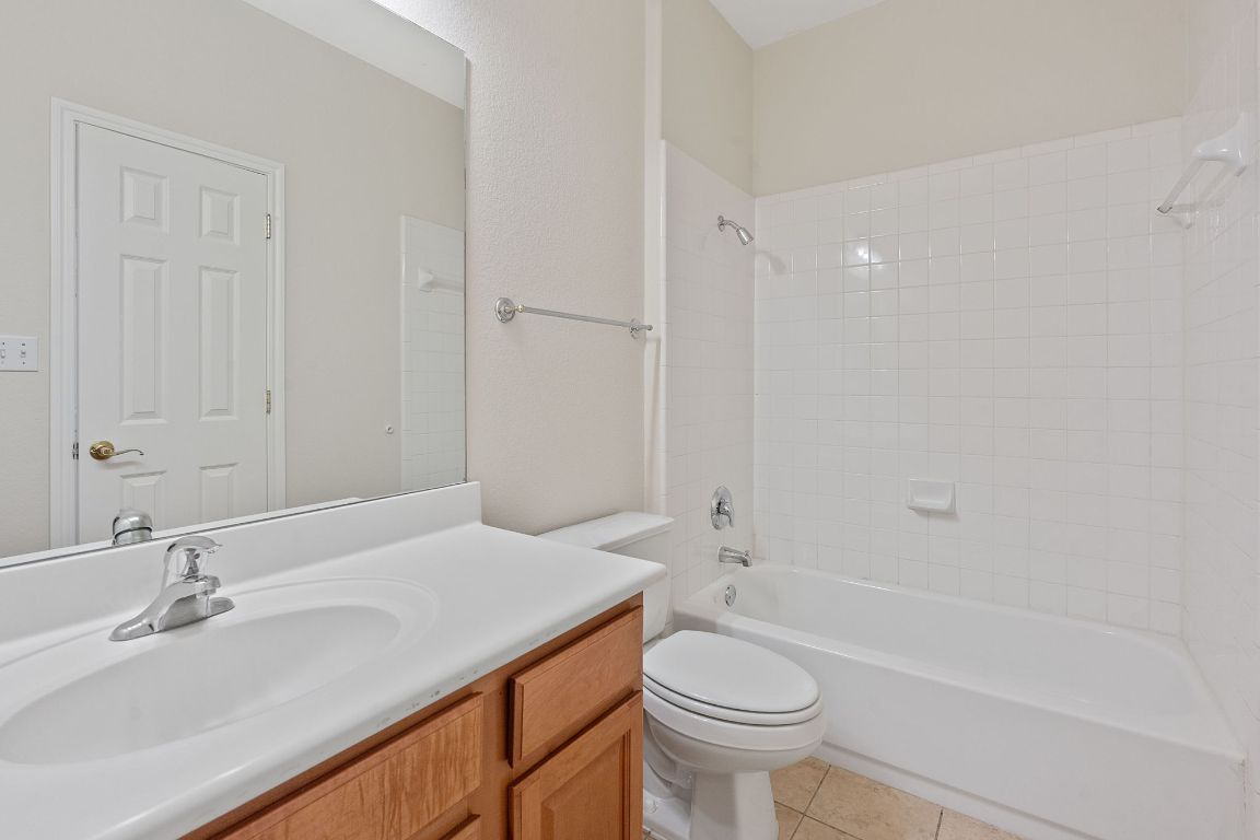 738 Nelson Ranch Road Cedar Park, TX 78613 - Photo 30 of 35 Bathroom featuring toilet, tile patterned flooring, vanity, and shower / washtub combination