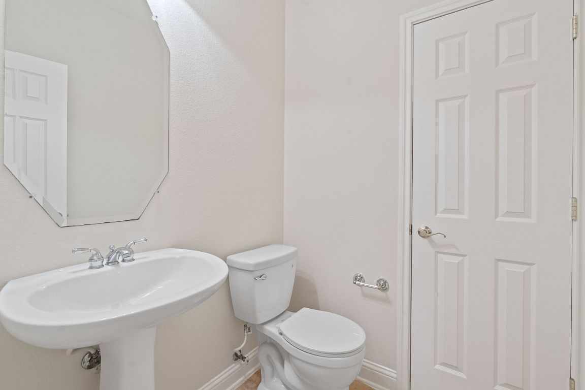 738 Nelson Ranch Road Cedar Park, TX 78613 - Photo 31 of 35 Half bathroom featuring baseboards, toilet, and a sink
