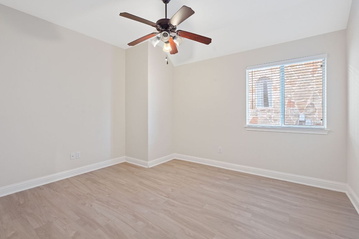 738 Nelson Ranch Road Cedar Park, TX 78613 - Photo 32 of 35 Unfurnished room featuring a ceiling fan, lofted ceiling, baseboards, and light wood finished floors