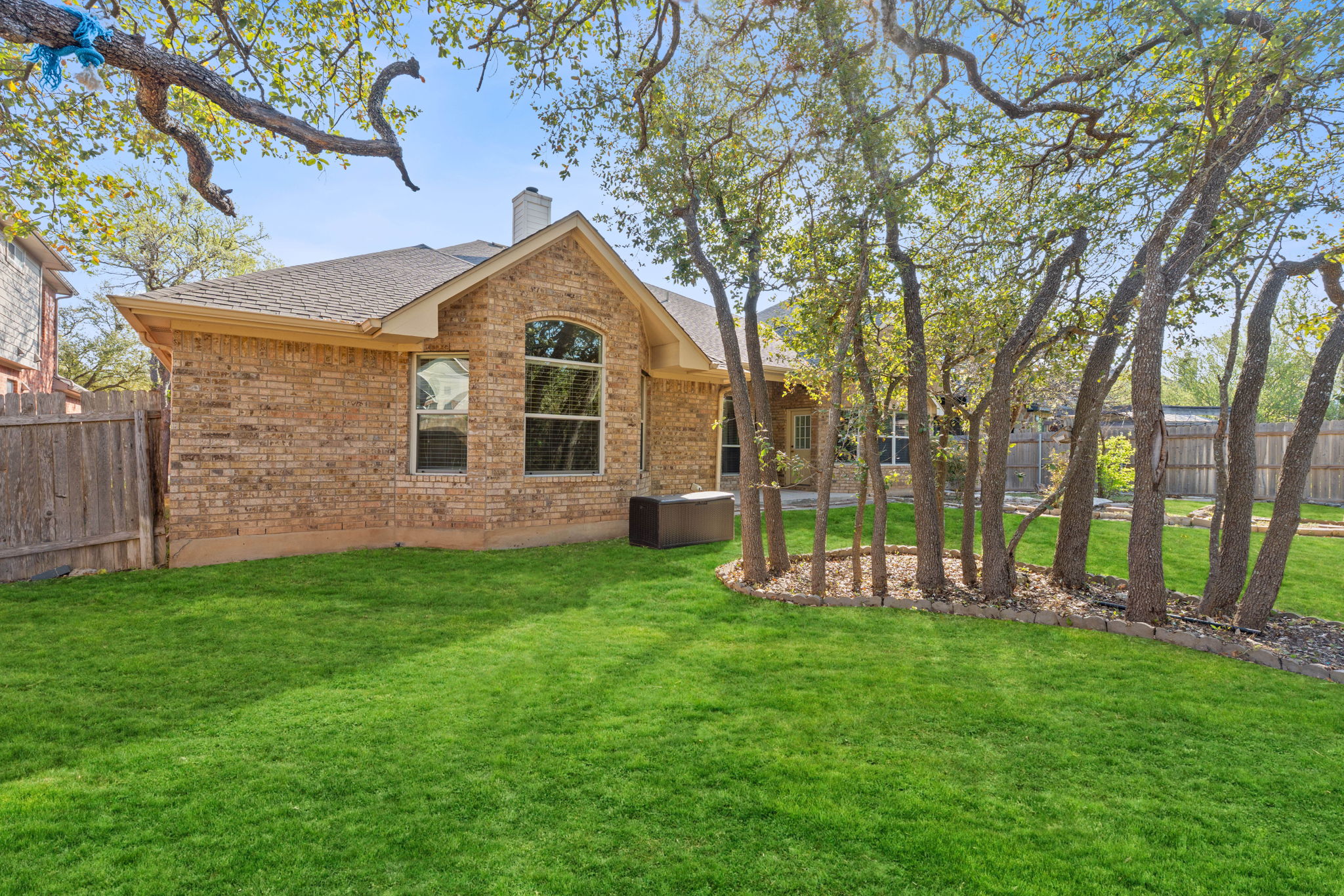 738 Nelson Ranch Road Cedar Park, TX 78613 - Photo 35 of 35 Rear view of property featuring a yard, fence, brick siding, a chimney, and a shingled roof